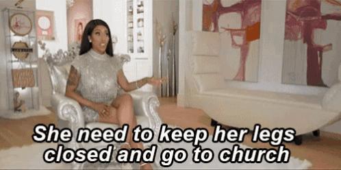 a woman in a silver dress is sitting in a chair and says she needs to keep her legs closed and go to church