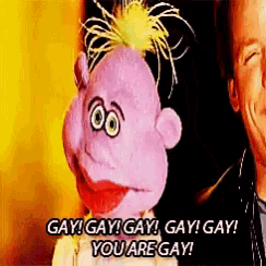 a purple puppet is standing next to a man and saying gay gay gay gay gay you are gay