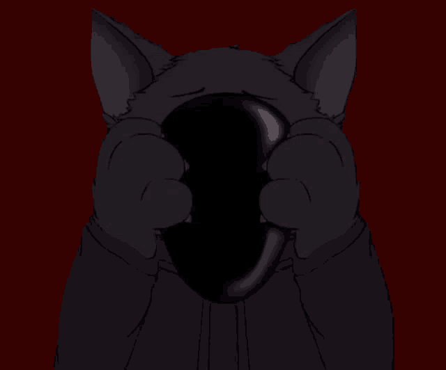 a black cat with red eyes holds a black object in its mouth
