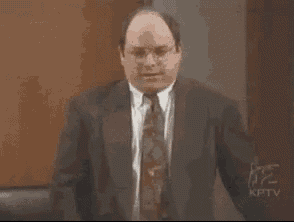 a man in a suit and tie is standing in front of a podium and saying well , i had .