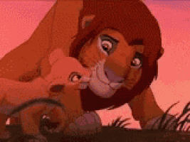 a lion and a lioness are standing next to each other in the grass .