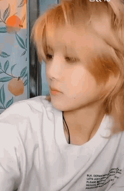 a close up of a person 's face with a white shirt on