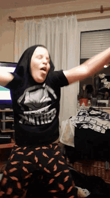 a woman wearing a black shirt that says panther is dancing