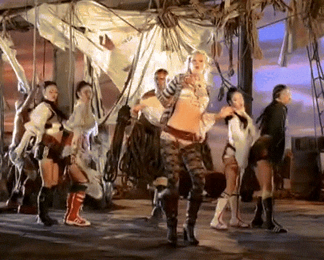 a group of women are dancing in front of a rope hanging from the ceiling