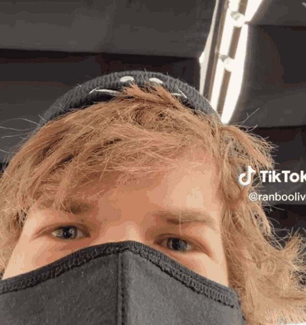 a close up of a person 's face with a tiktok logo visible