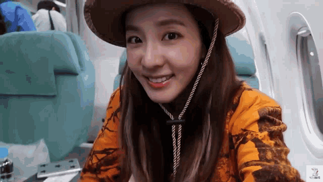 a woman wearing a cowboy hat and a hawaiian shirt