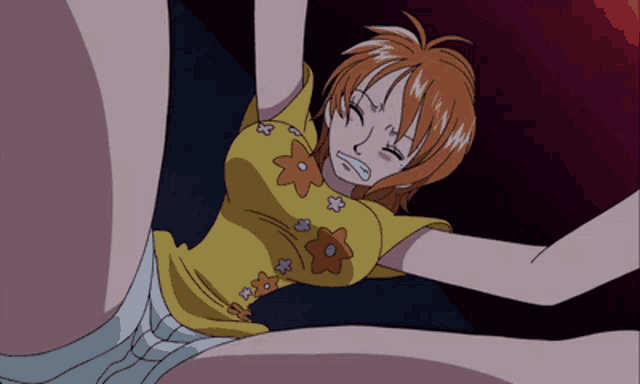 a woman in a yellow shirt with flowers on it is laying down