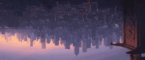 an upside down view of a city with a clock tower in the background