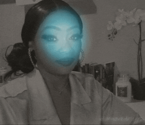 a black and white photo of a woman with a blue light behind her