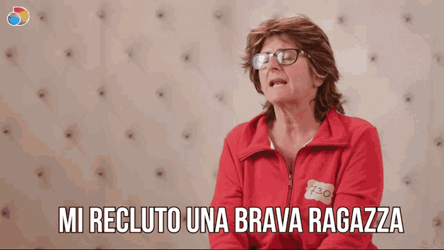 a woman wearing glasses and a red jacket that says 730 on it