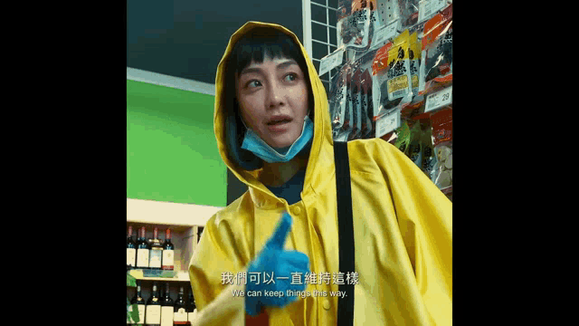 a woman wearing a yellow raincoat and gloves says we can keep things a little way