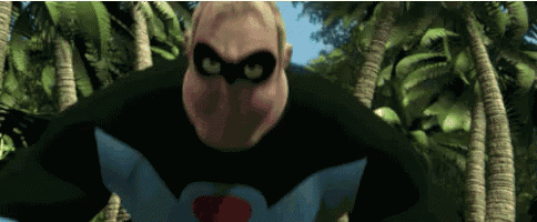 a man in a superhero costume is standing in a jungle .