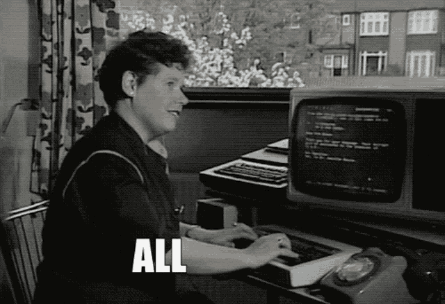 a black and white photo of a woman typing on a keyboard with the word all written in white letters