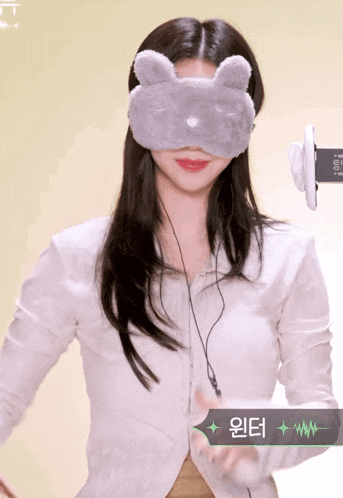a woman wearing headphones and a mask with a bunny face on it