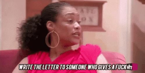 a woman is sitting on a couch and saying `` write the letter to someone who gives a fuck ''