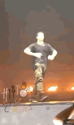 a man is dancing on a stage in front of a sign that says " history of once "