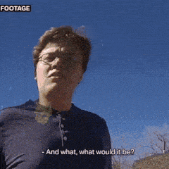 a man stands in front of a barn and a car and says and what what would it be