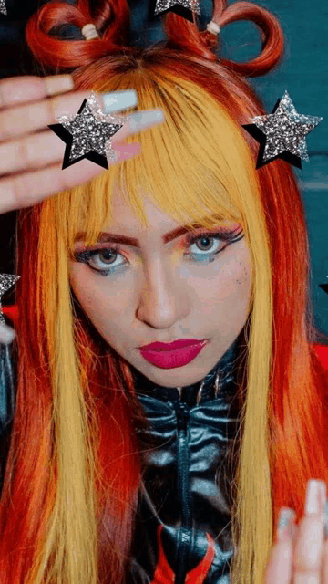 a woman with red and yellow hair has a star on her hair