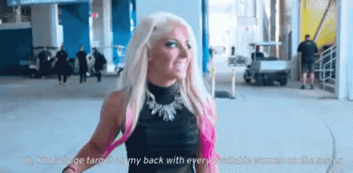 a woman with blonde hair is standing in a parking garage .