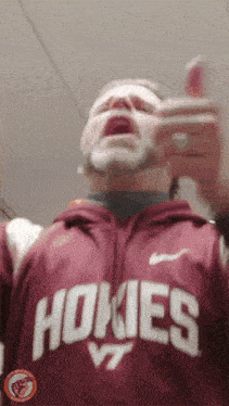 a man wearing a hoodie that says hokies vt on it