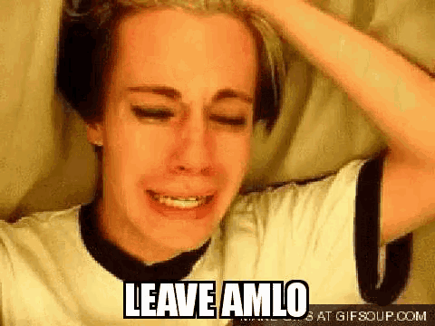 a young man is crying and holding his head with the words `` leave amlo '' written above him .