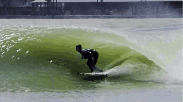 a man is riding a wave on a surfboard in the water