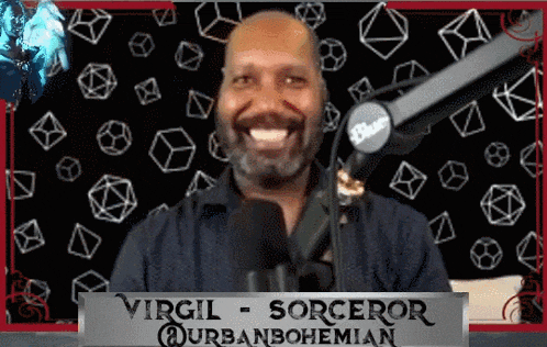 a man with a beard is smiling in front of a microphone and a sign that says virgil sorceror durbanbohemian