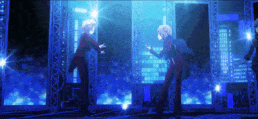 a couple of people standing on a stage with a blue background