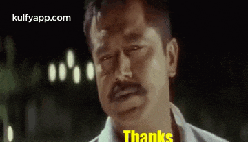 a man with a mustache is making a funny face and says `` thanks '' .
