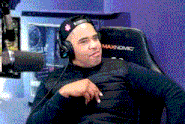 a man wearing headphones and a hat is sitting in a chair that says maxnomic