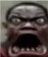 a close up of a person 's face with a very angry look on it .