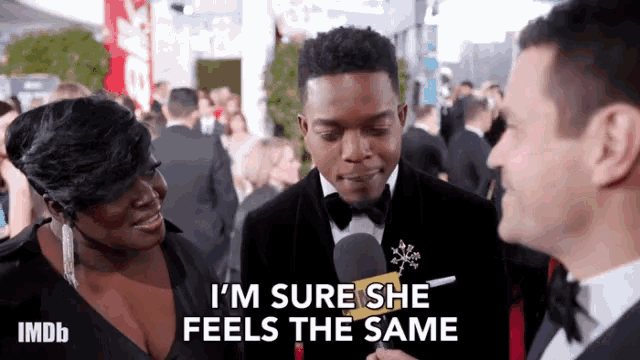 a man in a tuxedo is talking to a woman and says " i 'm sure she feels the same " .