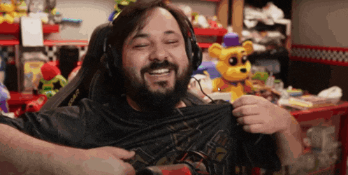 a man with a beard wearing headphones and a black shirt