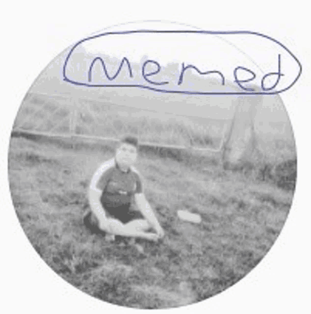 a black and white photo of a boy sitting in the grass with the word memed written on it