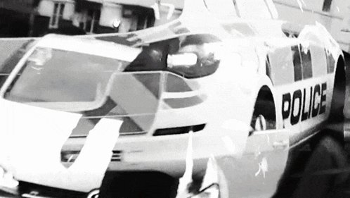 a black and white photo of a white police car