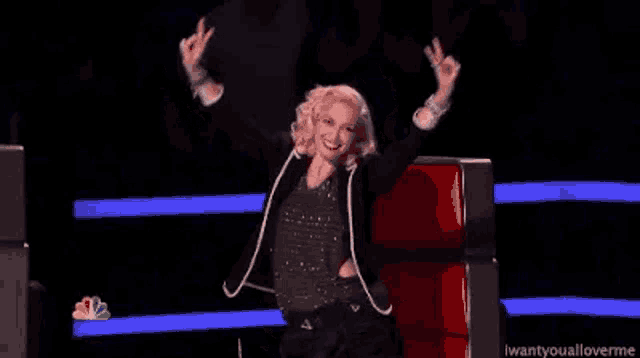 a woman is sitting in a chair with her hands in the air .