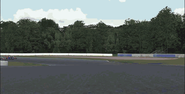 two racing cars are on a track and one has the number 74 on it