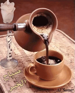 a cup of coffee is being poured from a coffee pot on a saucer