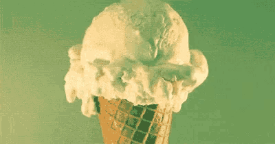 a close up of an ice cream cone with a scoop of ice cream on top