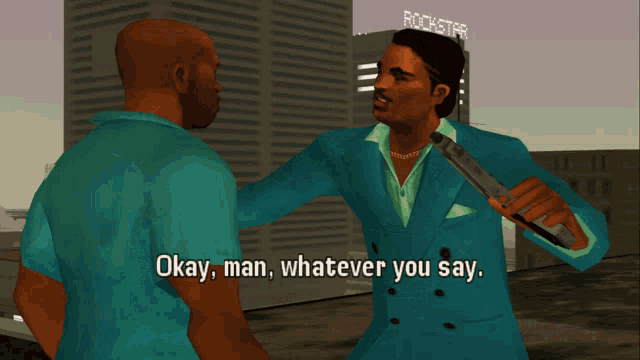 a man in a blue suit is holding a microphone and talking to another man in front of a rockstar building