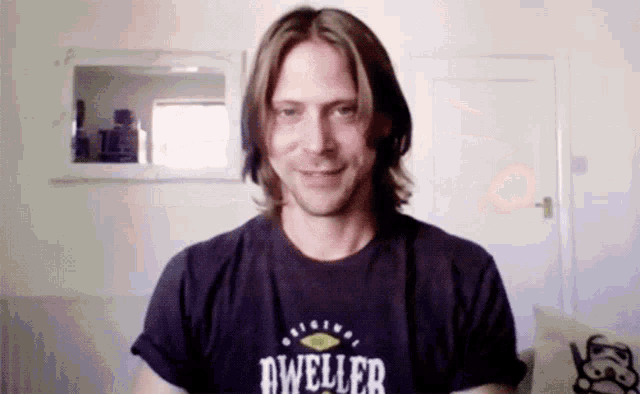 a man wearing a shirt that says dweller