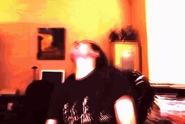 a blurry picture of a person in a black shirt with the letter n on it