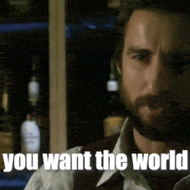 a man with a beard is standing in front of a bar and says you want the world