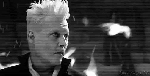 a black and white photo of a man with white hair and a mohawk .