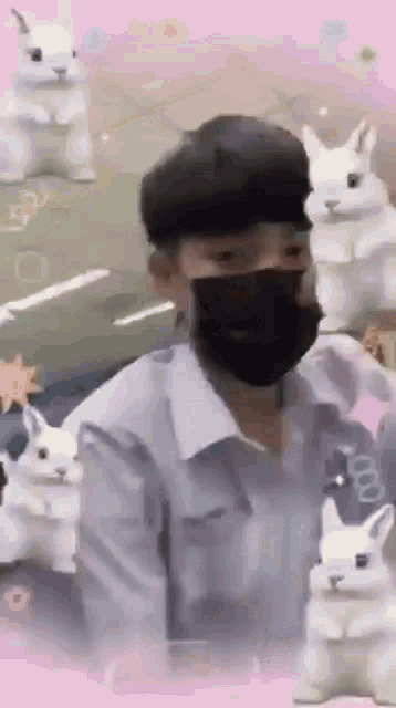 a man wearing a mask is standing in front of a bunch of white rabbits .