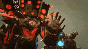 a robot with a lot of red lights on it 's head is waving .