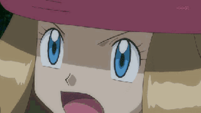 a close up of a girl 's face with a pink hat on