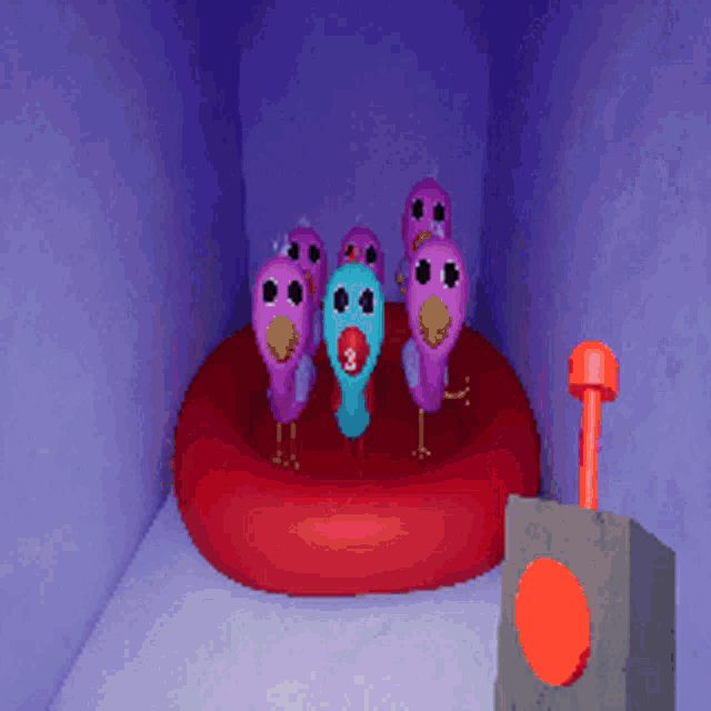 a group of pink and blue birds are standing on a red circle with the number 9 on their faces