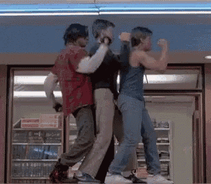 a group of men are dancing in a store .
