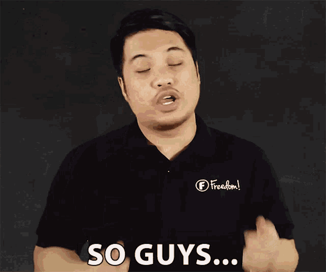 a man wearing a black shirt with the word freedom on it